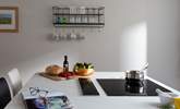 The induction hob sits neatly within the large island.  - Thumbnail Image