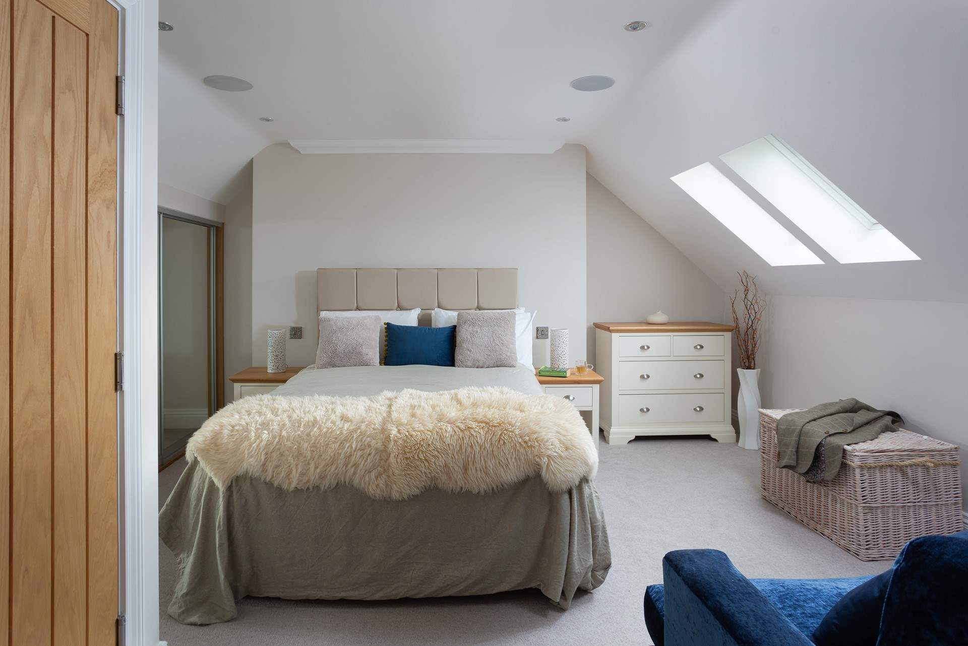 The second floor has a spacious bedroom with a king-size bed and an en suite bathroom. 