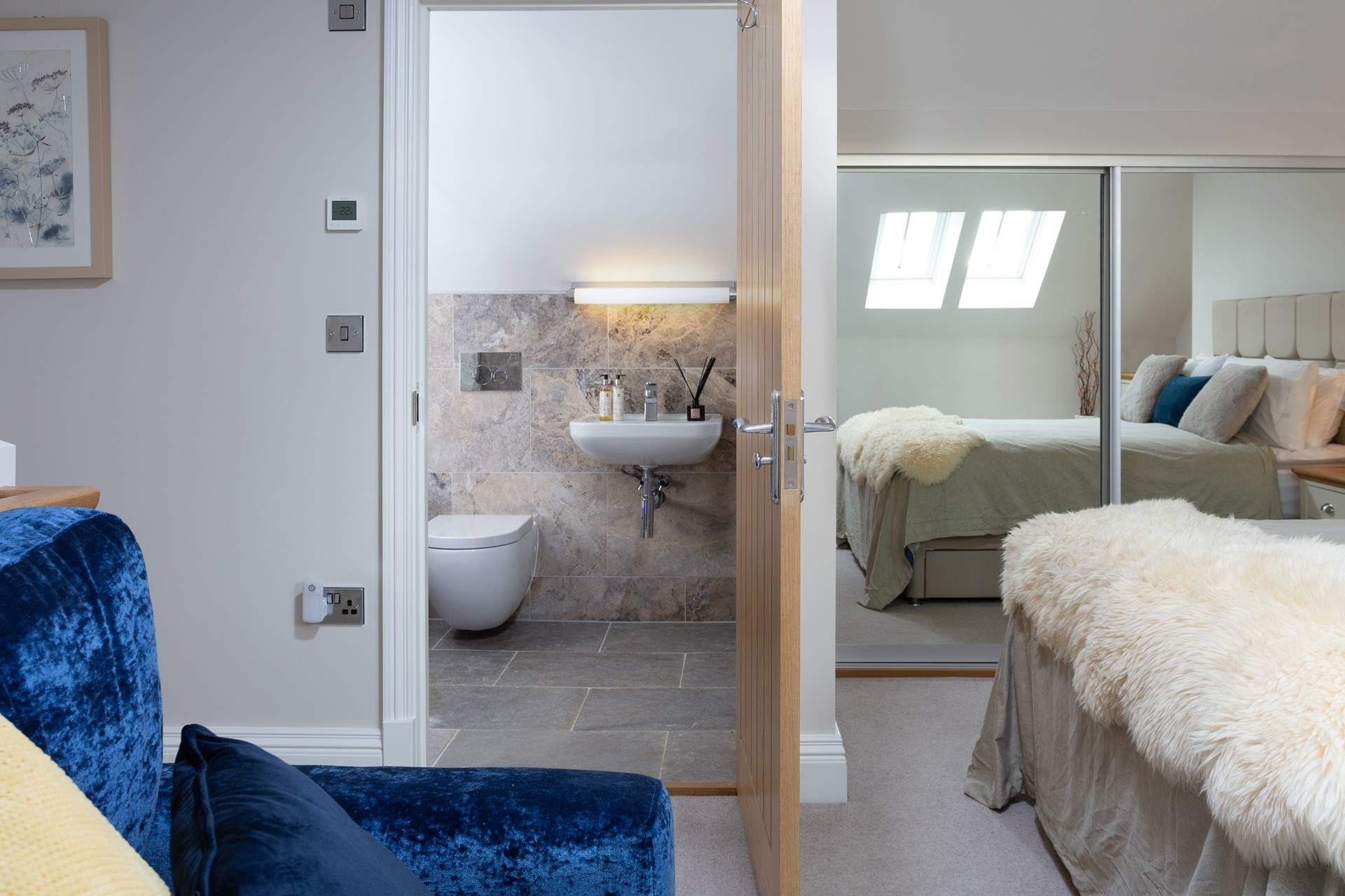 The Velux window's light is reflected in the mirrors making this a lovely bright bedroom.