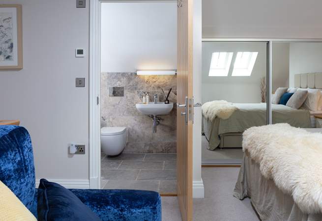 The Velux window's light is reflected in the mirrors making this a lovely bright bedroom.