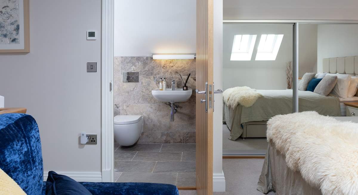 The Velux window's light is reflected in the mirrors making this a lovely bright bedroom.