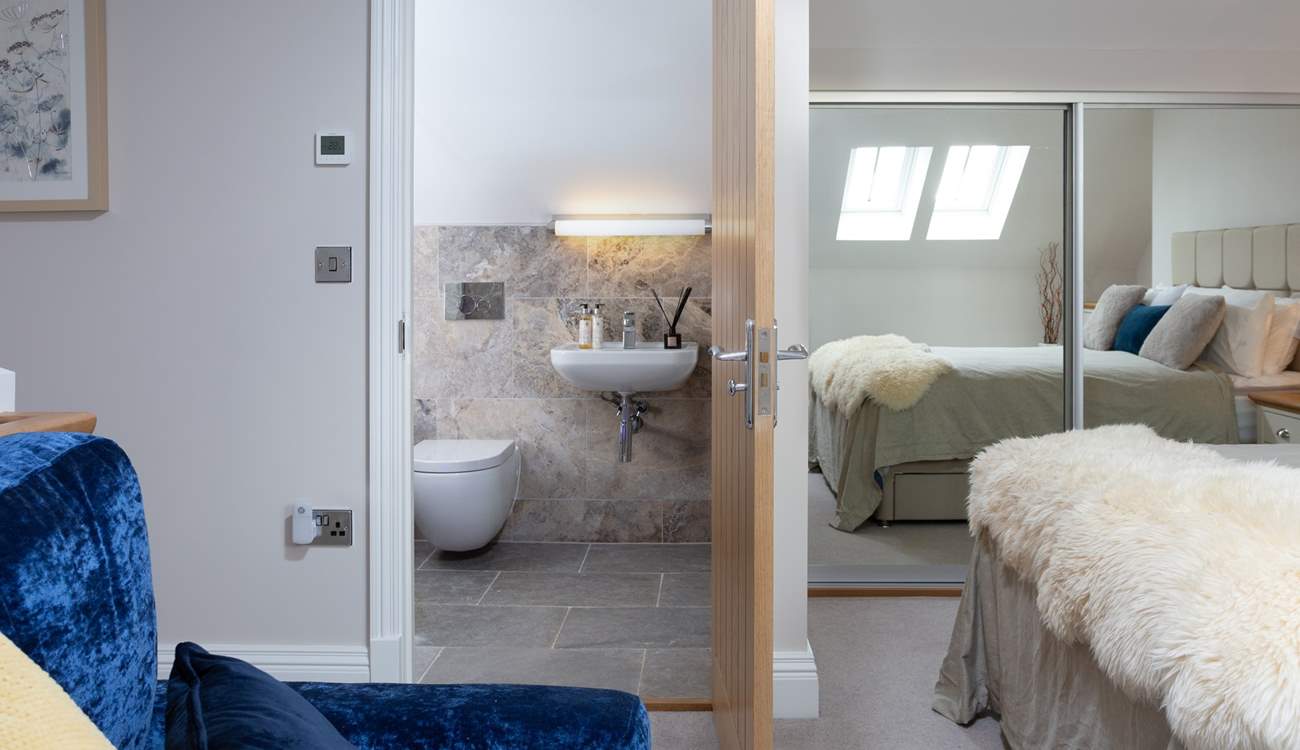The Velux window's light is reflected in the mirrors making this a lovely bright bedroom.