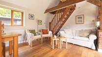 Unwind in this cosy living area, after a busy day exploring. Please note, the stairs lead to a locked storage area which is not available for guests' use.