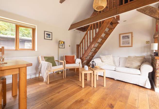 Unwind in this cosy living area, after a busy day exploring. Please note, the stairs lead to a locked storage area which is not available for guests' use.