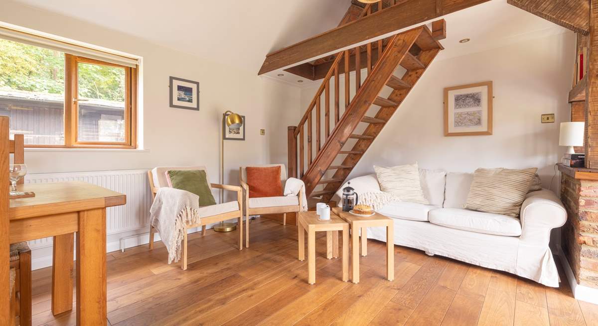 Unwind in this cosy living area, after a busy day exploring. Please note, the stairs lead to a locked storage area which is not available for guests' use.