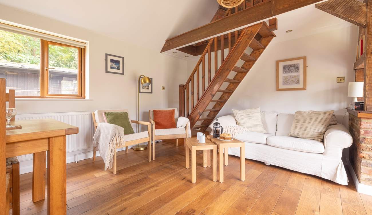 Unwind in this cosy living area, after a busy day exploring. Please note, the stairs lead to a locked storage area which is not available for guests' use.