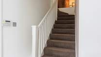 Stairs lead to the bedrooms on the first floor. 