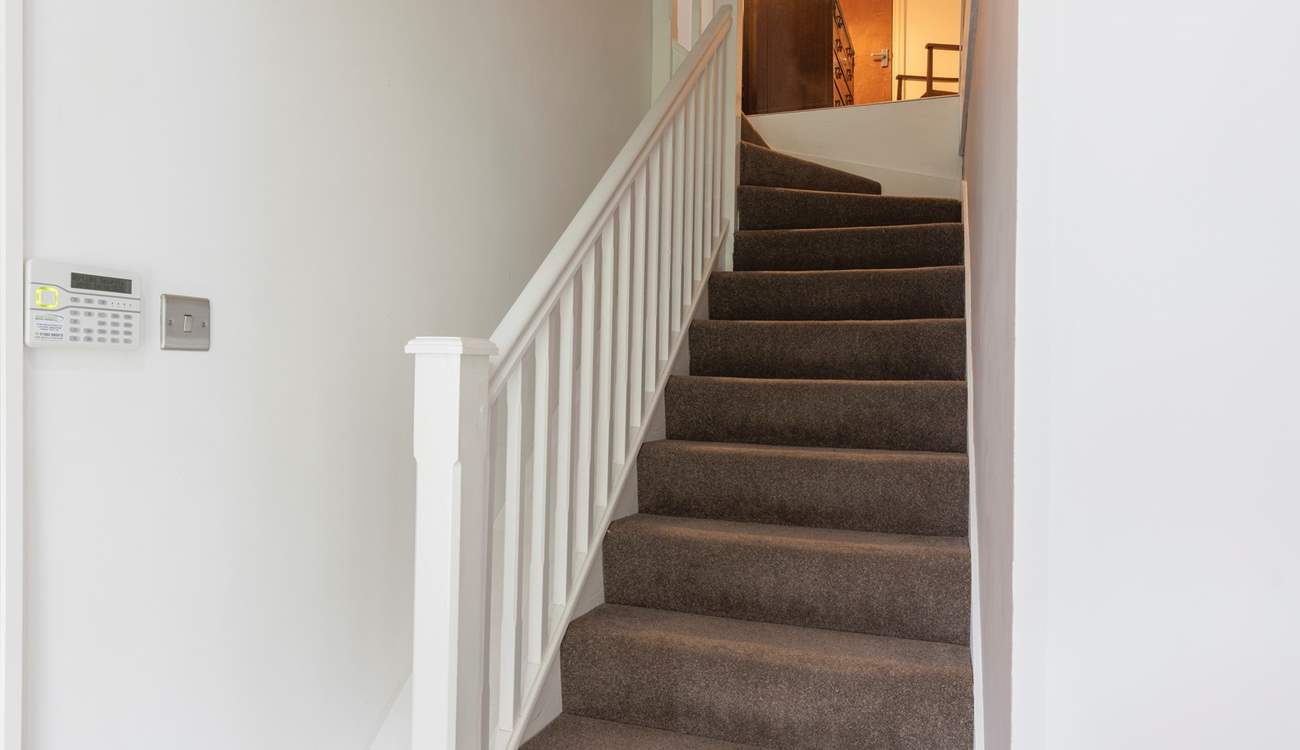 Stairs lead to the bedrooms on the first floor. 