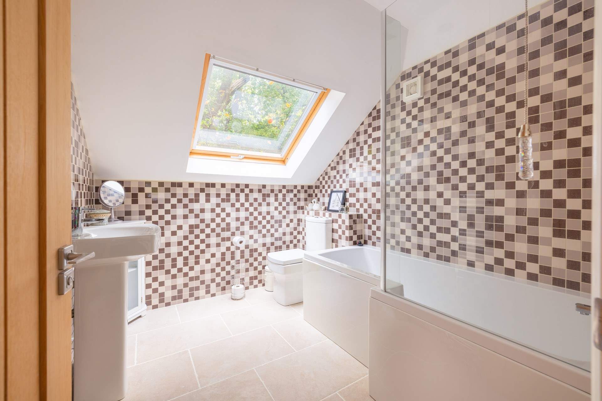 The en suite bathroom has a bath with fitted shower.