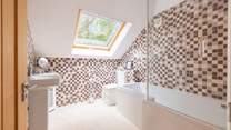The en suite bathroom has a bath with fitted shower.