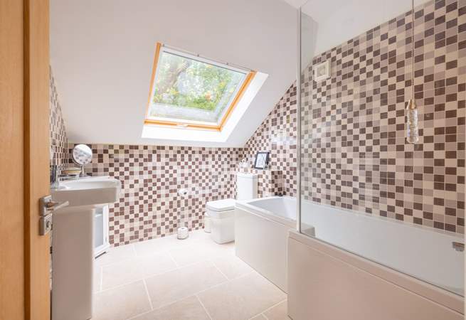 The en suite bathroom has a bath with fitted shower.