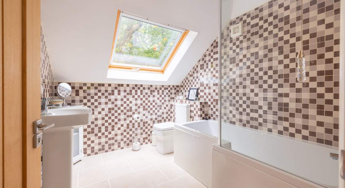 The en suite bathroom has a bath with fitted shower.