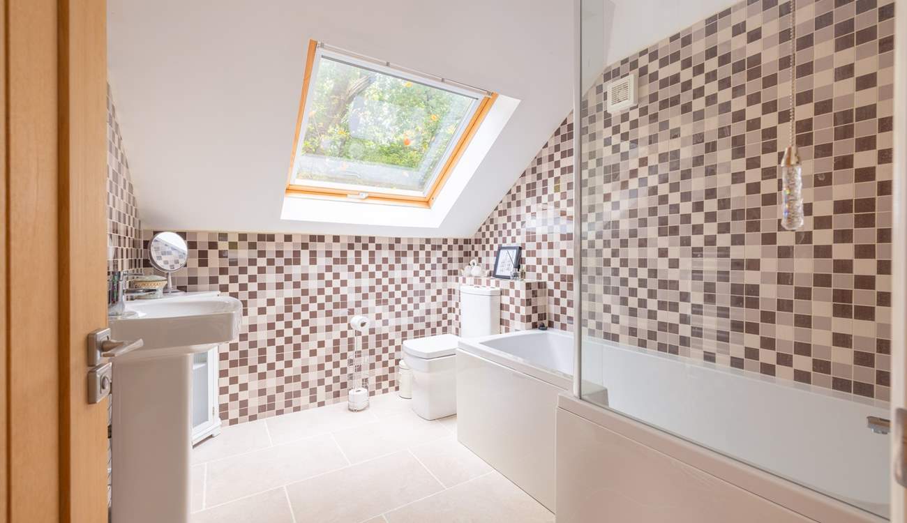 The en suite bathroom has a bath with fitted shower.