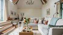 The light and airy sitting-room is on the first floor with vaulted ceiling and access to the patio area.