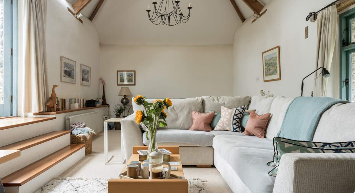 The light and airy sitting-room is on the first floor with vaulted ceiling and access to the patio area.