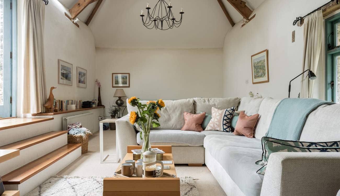 The light and airy sitting-room is on the first floor with vaulted ceiling and access to the patio area.