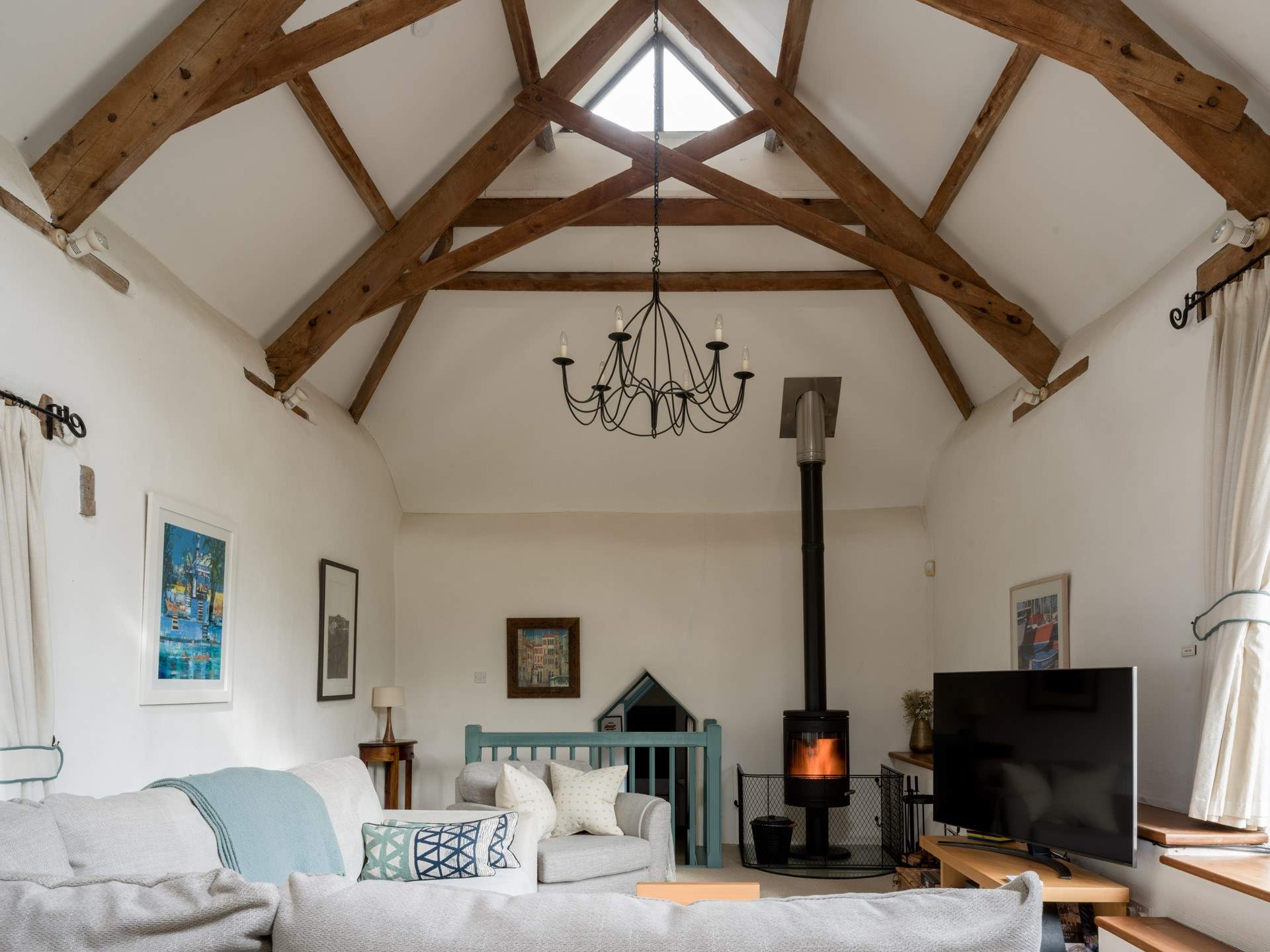 On those chillier days, light the wood-burner and snuggle down in front of the television. The door to bedroom 3 is down a few stairs from the sitting-room.