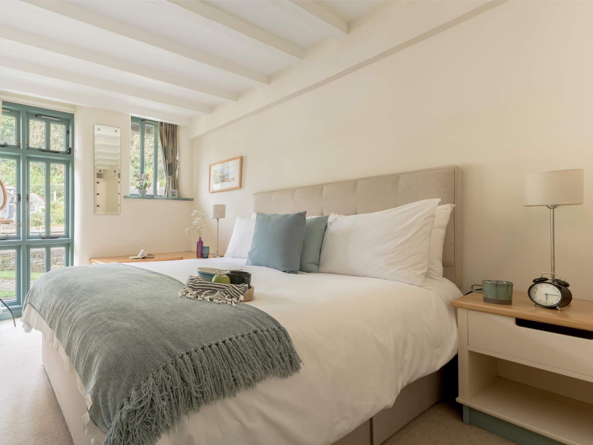 Bedroom 1 on the ground floor has a sumptuous king-size bed and views of the creek.