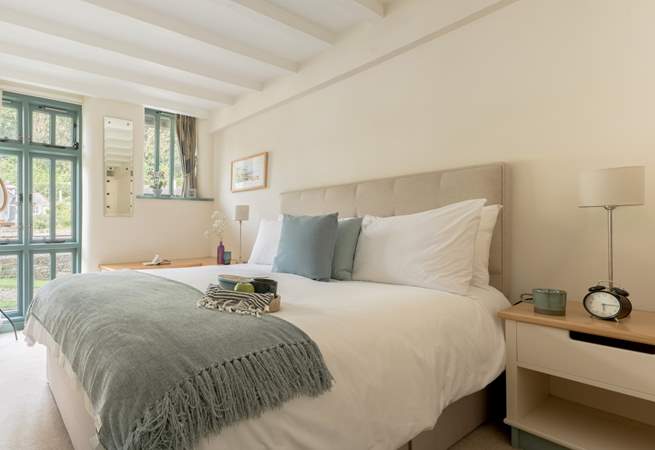 Bedroom 1 on the ground floor has a sumptuous king-size bed and views of the creek.