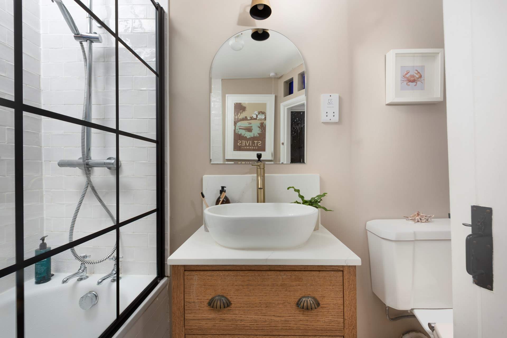 A vintage inspired bathroom with a bath to wash away your sandy day.