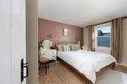 Drift off to sleep in this elegant king-size bed.