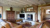 Watch a movie in front of the cosy wood-burner in this beautiful sitting-room.