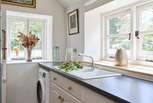 Utility-room with washing machine.