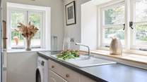 Utility-room with washing machine.