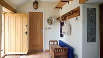 Handy cloakroom area for coats, wellies, dirty walking shoes and sandy beach items.