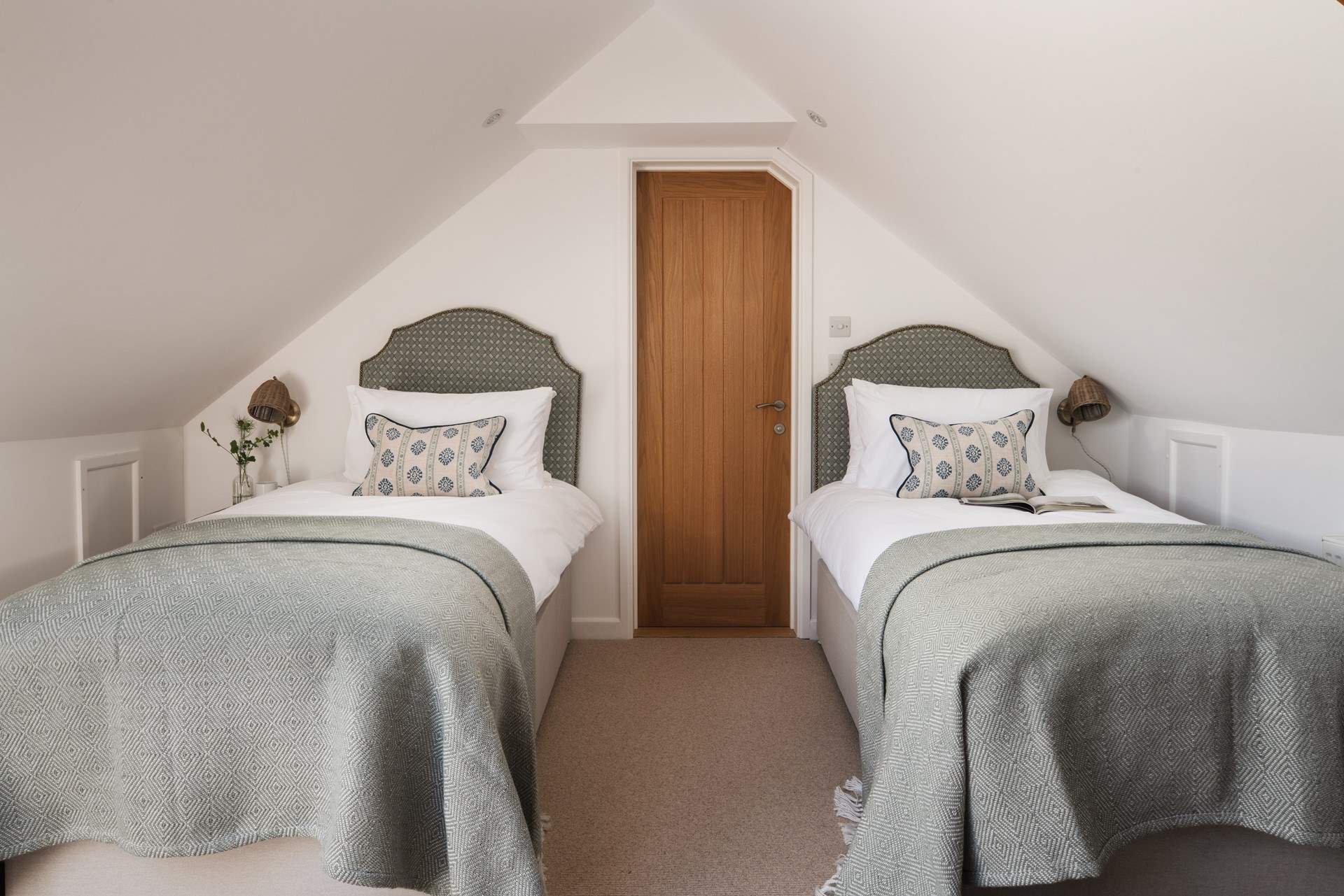 Twin beds await in the second bedroom. This room can interlink with bedroom 1, making it ideal for families.
