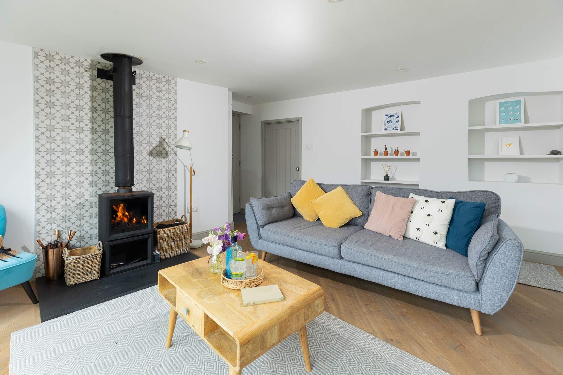 The sitting-area overlooks the garden and has a cosy wood-burner. 