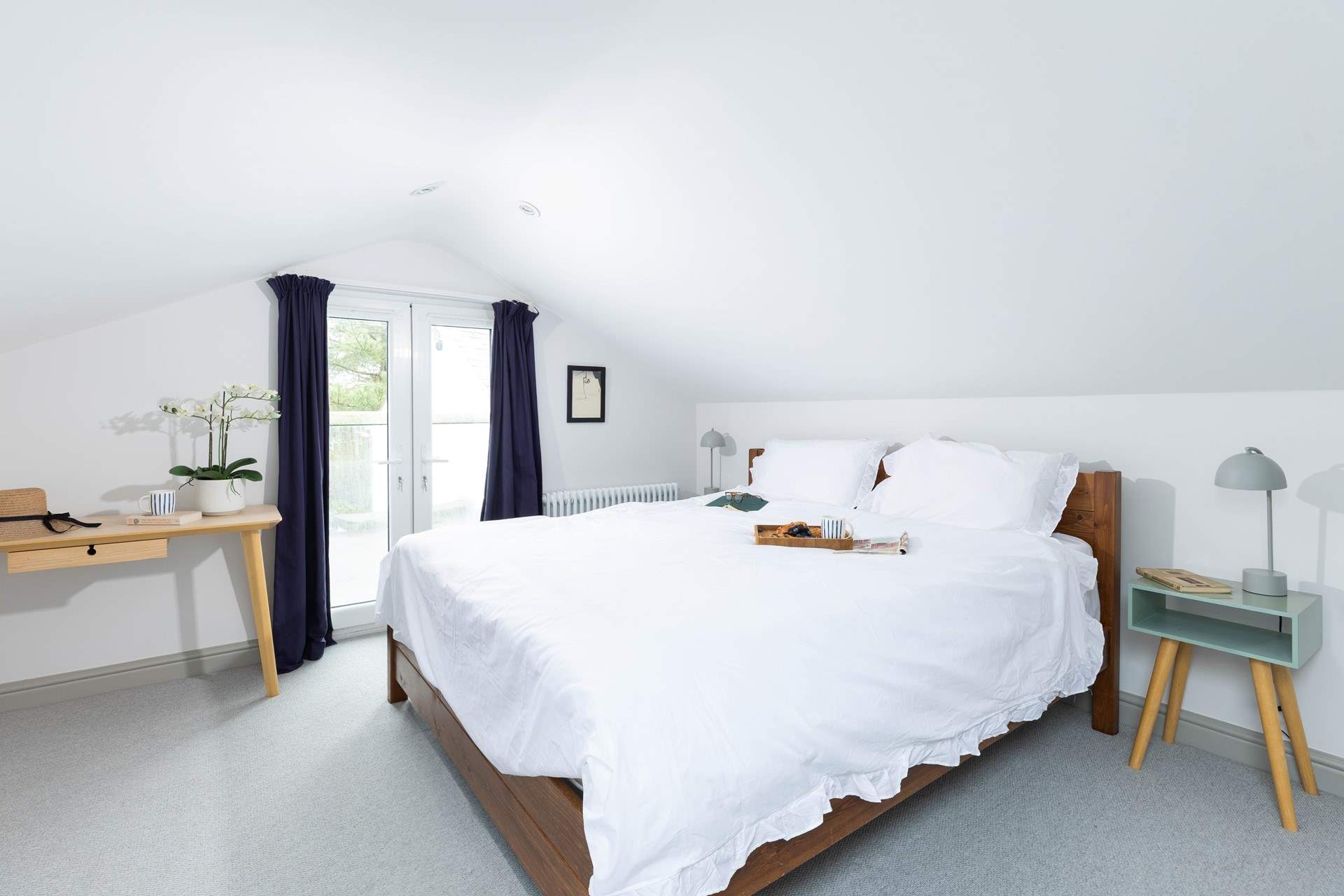 This super-king bed invites you to stretch out and relax. Please watch your head on the sloping ceilings (Bedroom 1).  