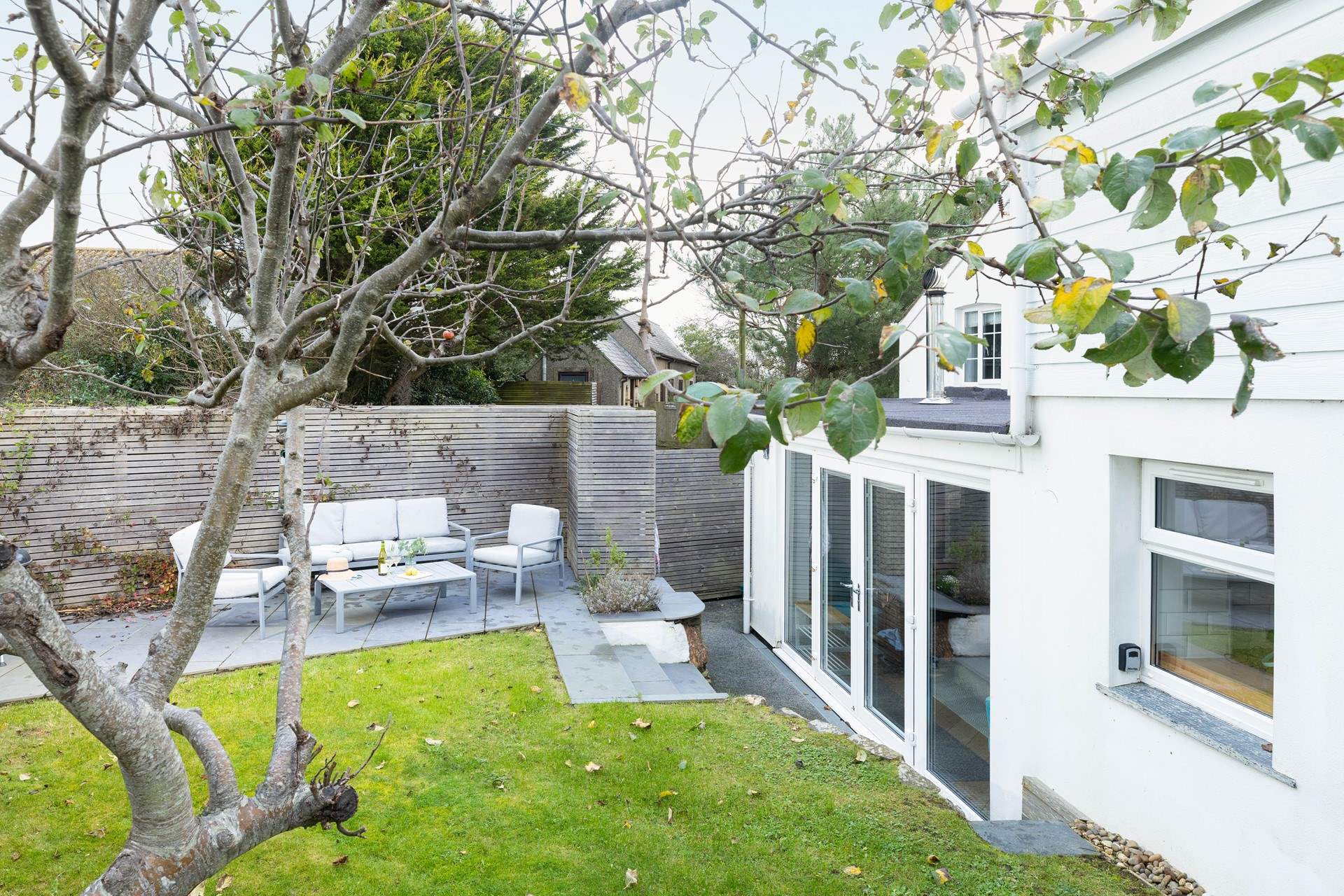 Steps lead down to the back and front doors from the garden. 