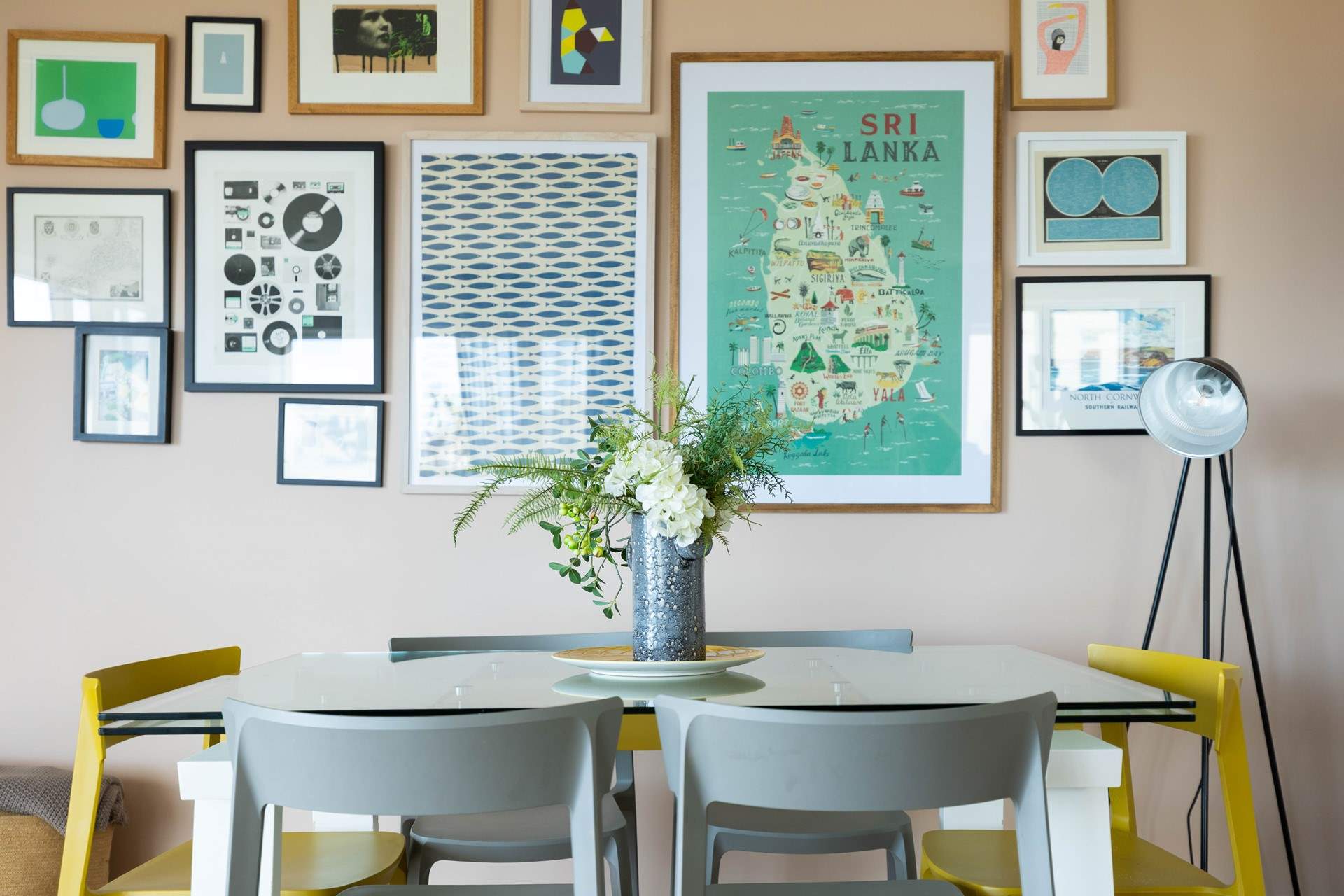 The dining-table is tucked next to the eclectic art and fantastic collection of books. 