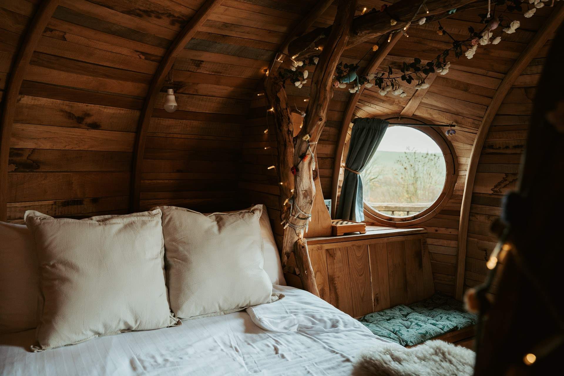 Sleep beneath the fairy-light wrapped branches in luxury linens. 