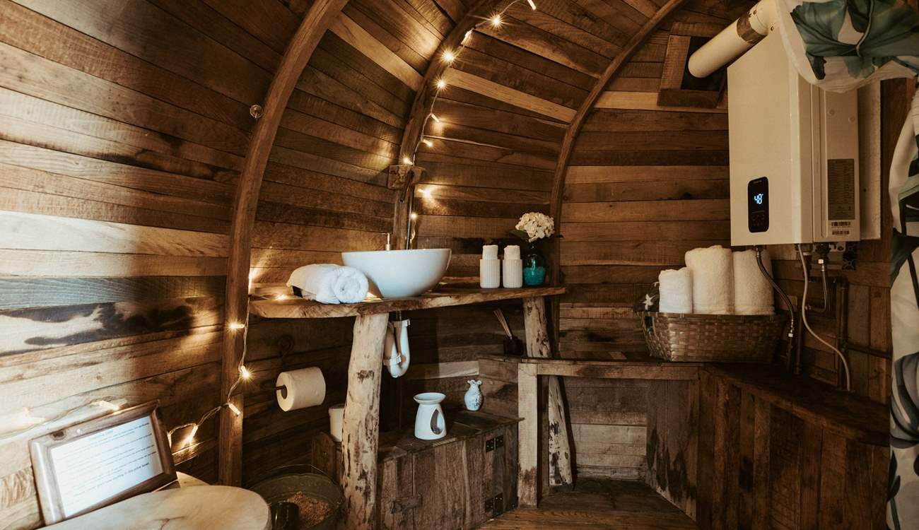 Just beyond the kitchen, you’ll find the curved shower-room with compostable toilet.