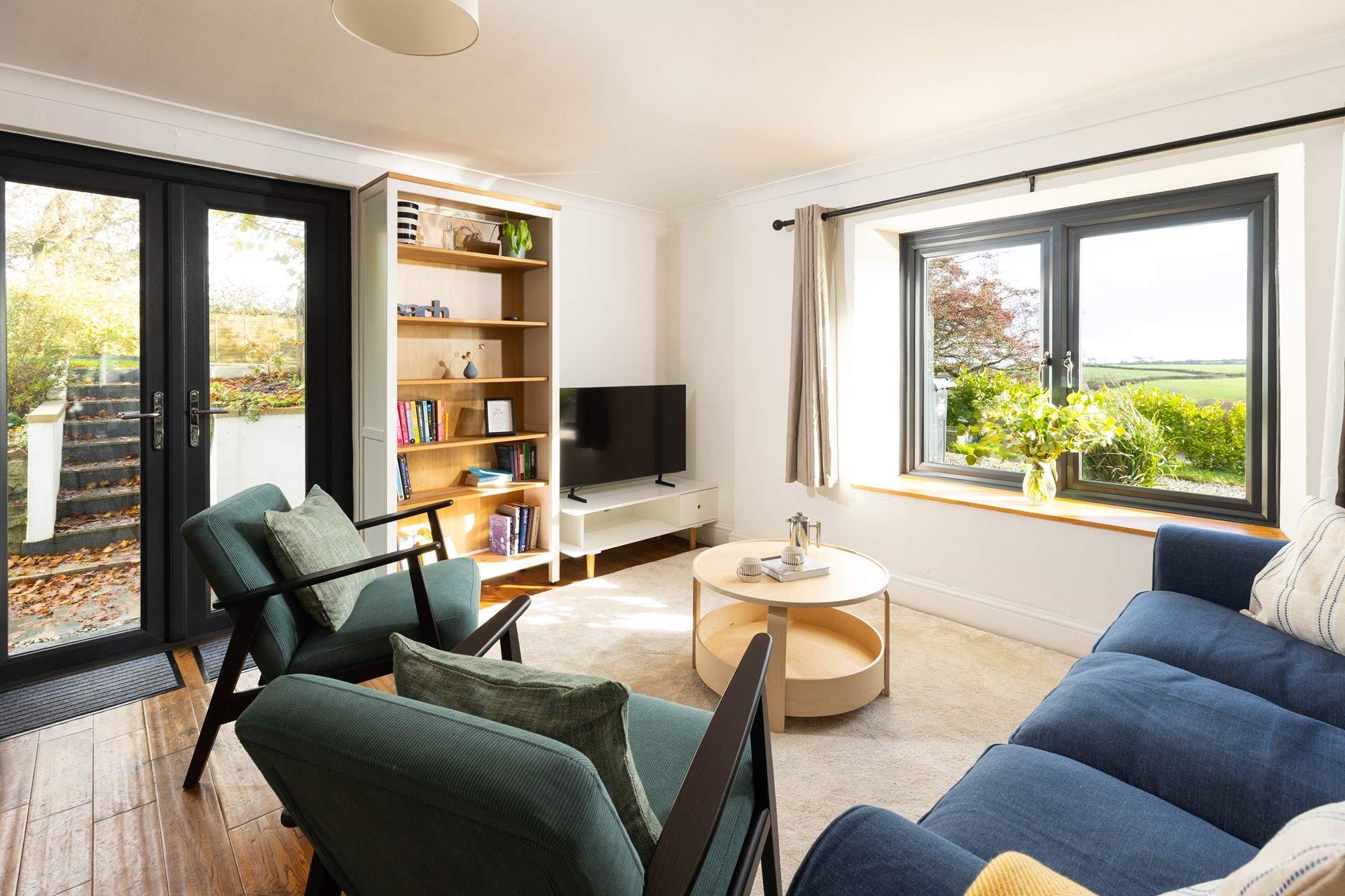 Watch a movie on the Smart TV or just admire the view! Patio doors lead to the steps into the garden. 