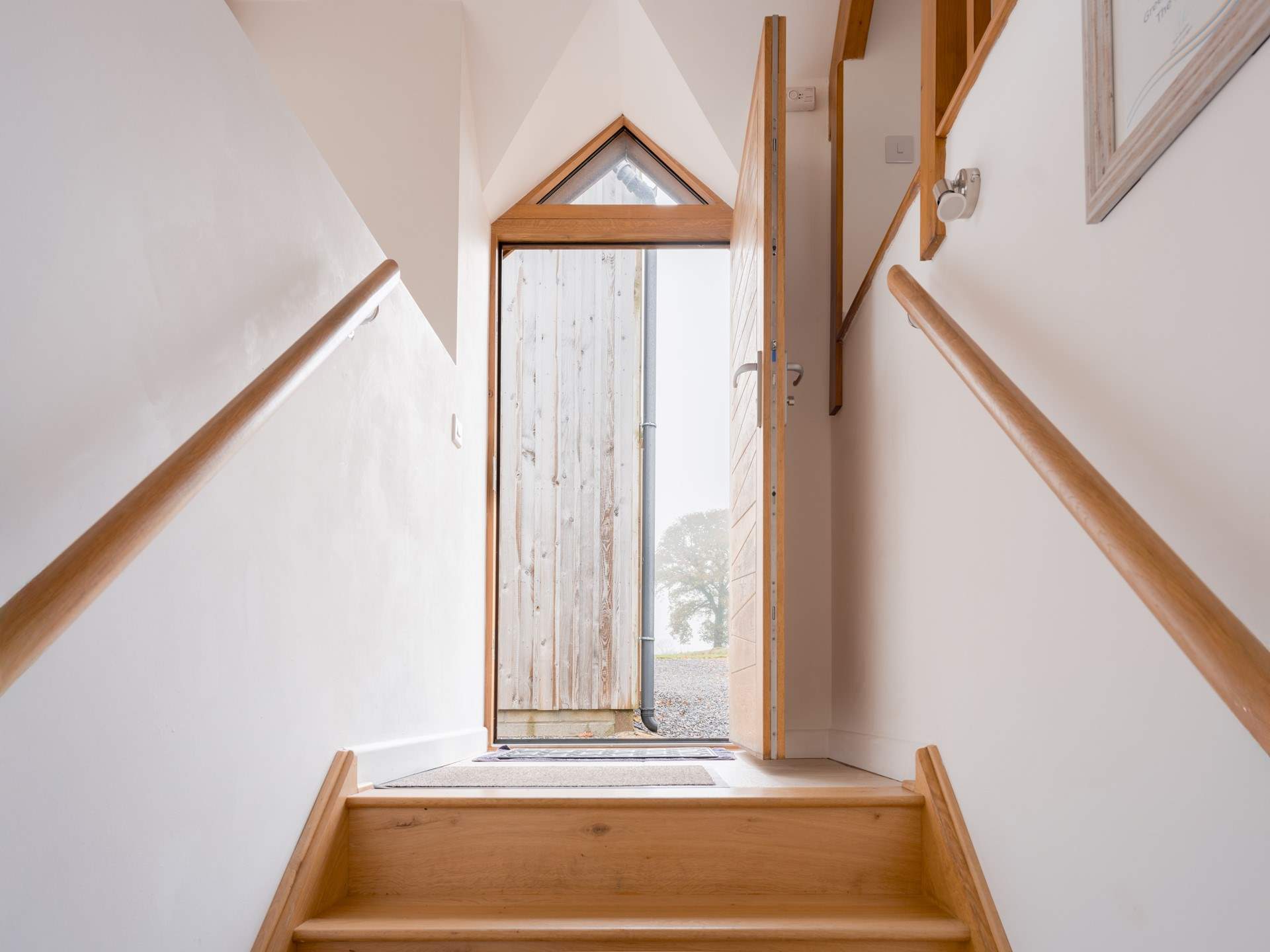 Steps lead down from the front door and will also take you out to the parking-area and games barn.