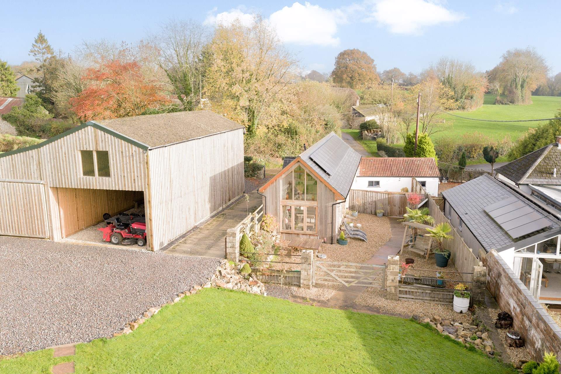 Giving a sense of perspective with the parking area and games barn to the left, then The Stables, and to the right, its sister property (also bookable), The Byre.