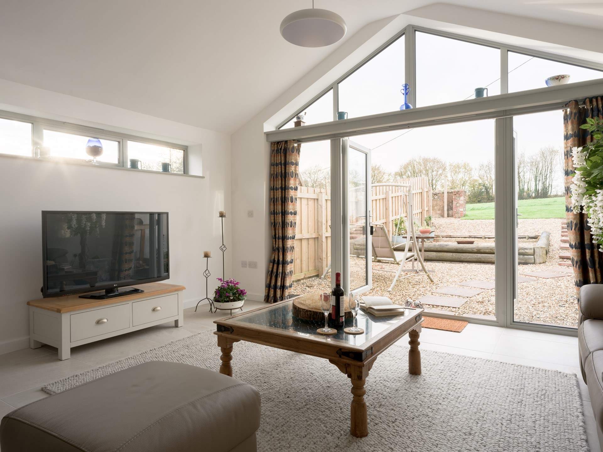 As you wander down through the private patio space you enter straight into the vaulted living space. Flooded with natural light and styled in a palette of toned down neutrals - such an inviting place to spend time.