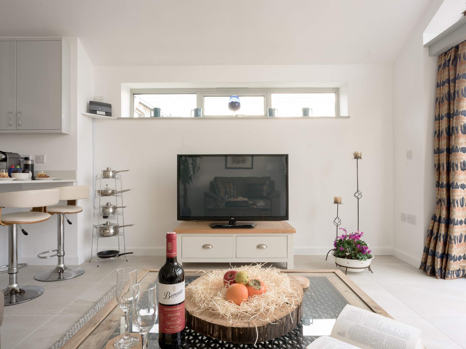 The living area features a large Smart TV and is set up very socially with its open kitchen layout. Perfect for a bit of time out together.