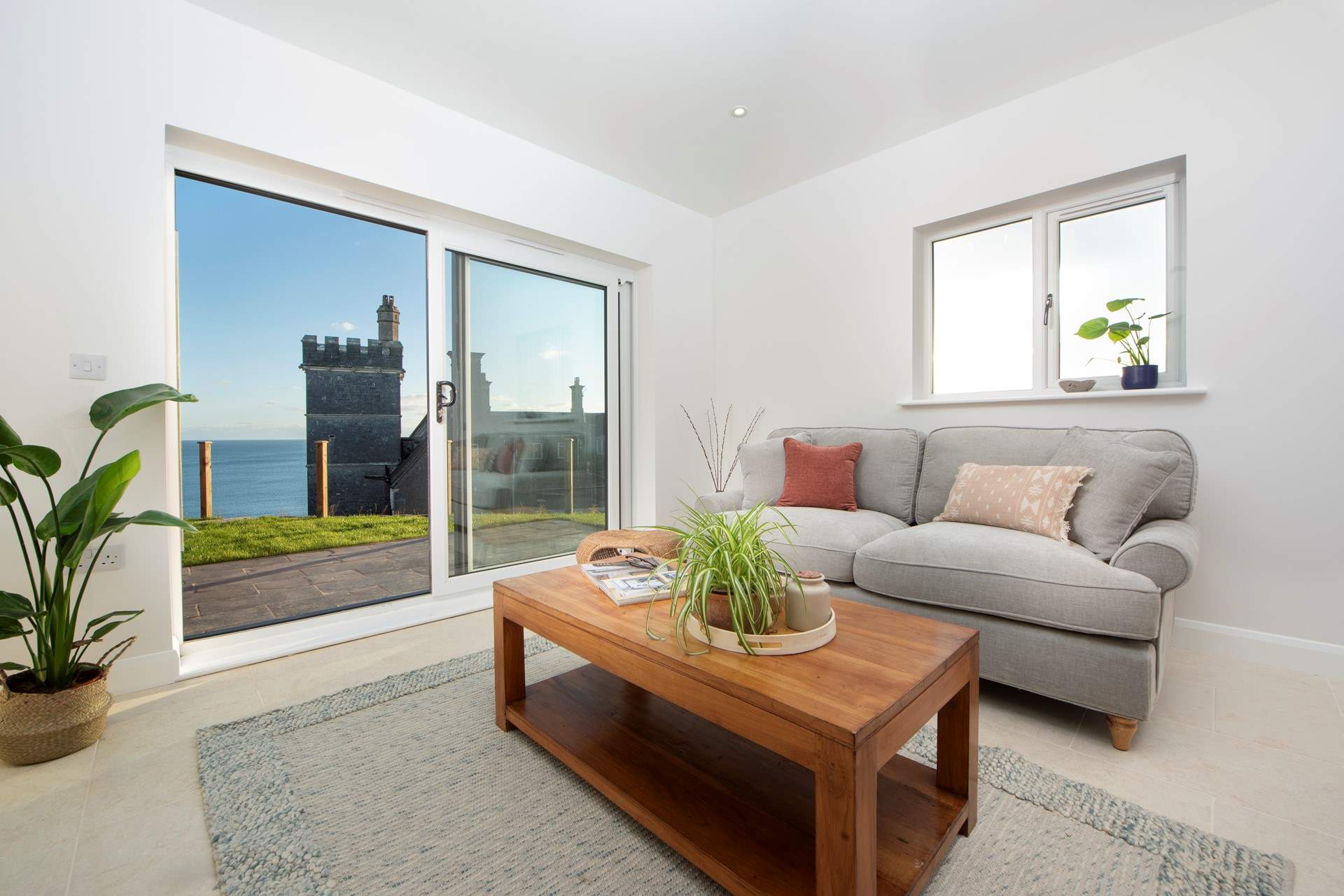 Unwind in the living area enjoying views of the ocean and the old Whitsand Bay Hotel, now sadly empty.