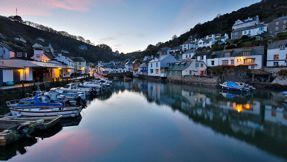 Polperro is a picturesque Cornish fishing village with narrow lanes, quaint cottages, and scenic harbour views