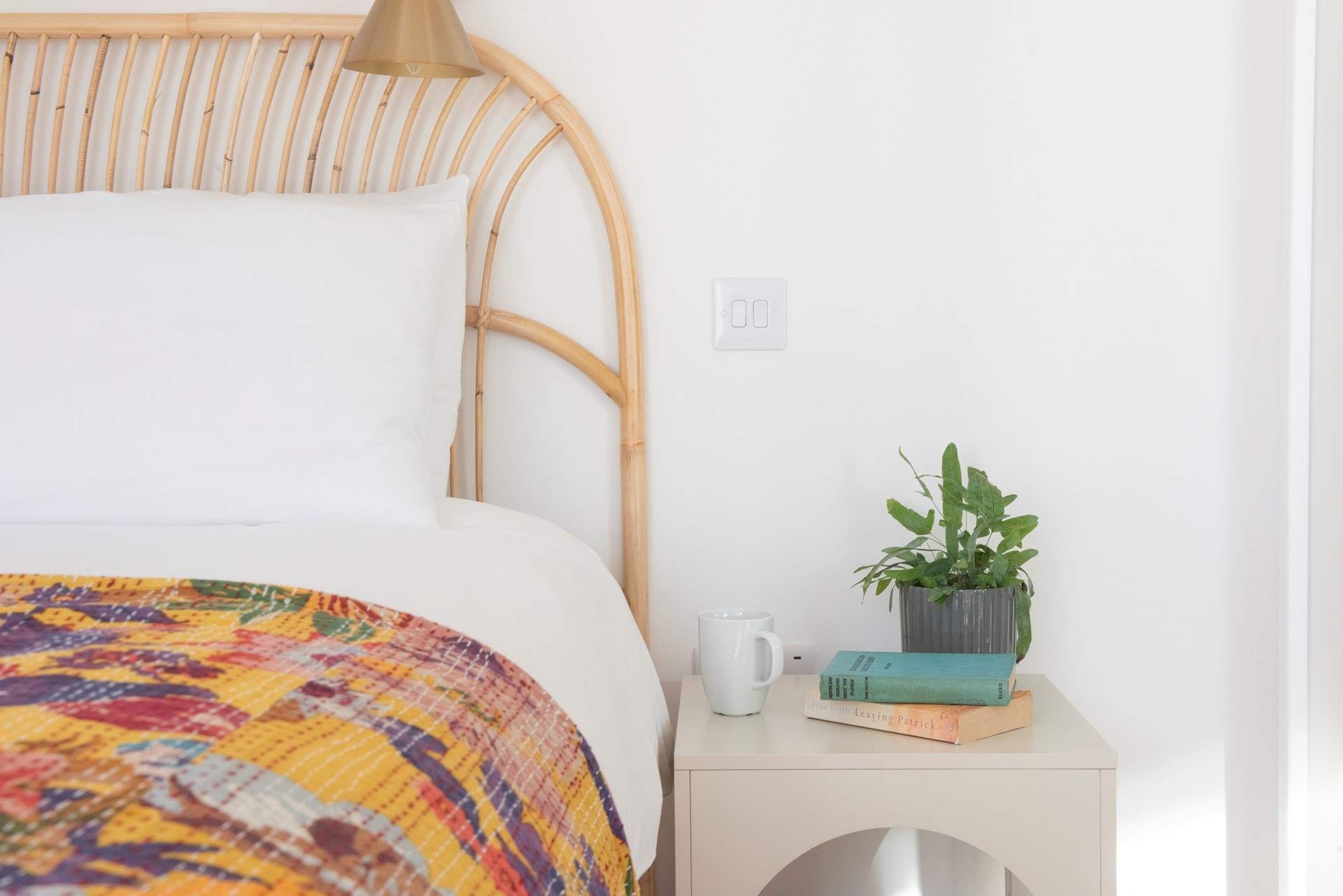 The pretty bedspread adds a lovely pop of colour.