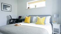Bedroom 1 has an en suite shower-room, a space to work and a comfortable bed.