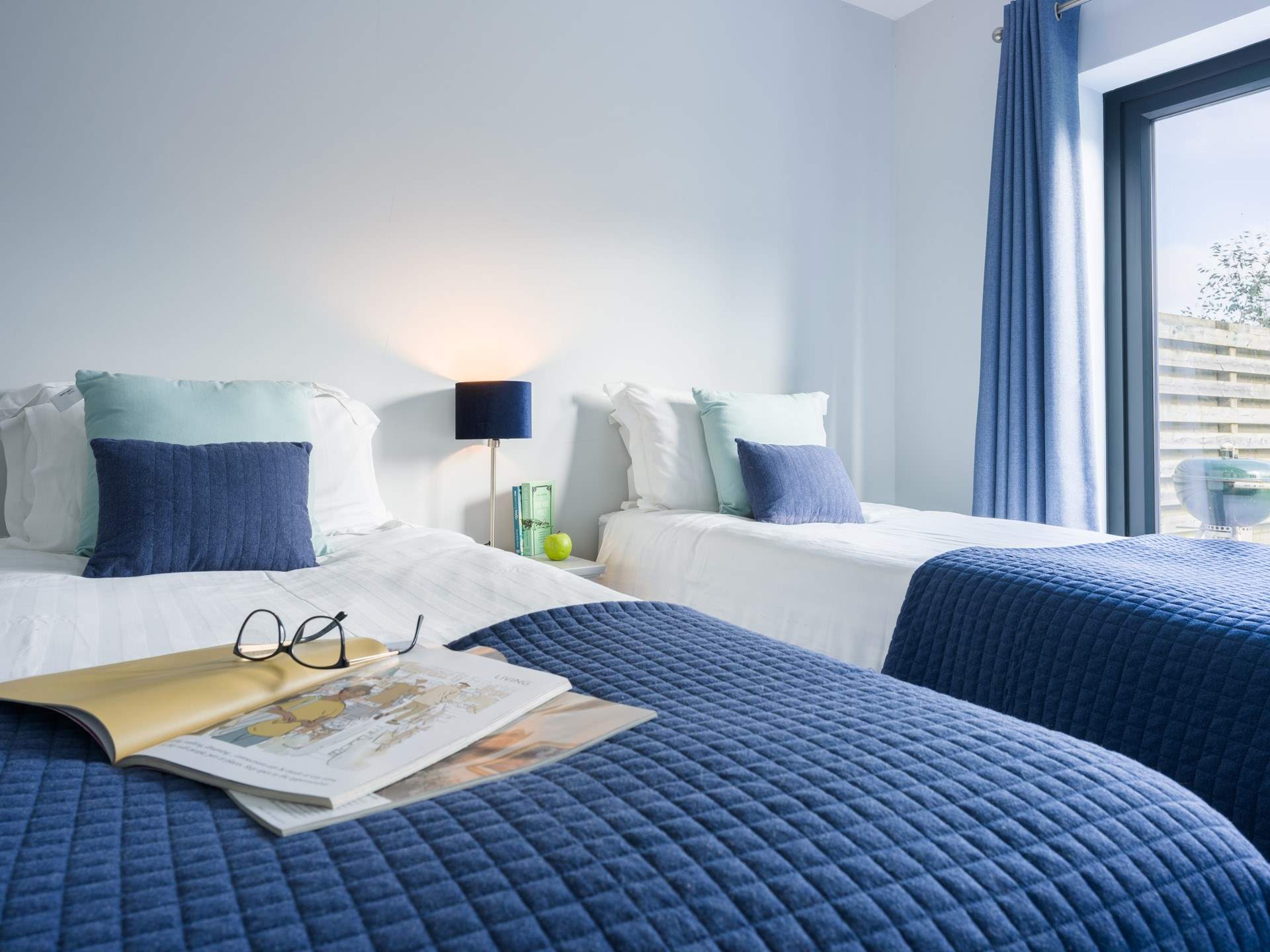 Decorated in coastal tones, the twin room will work for adults or children. There's also French doors out to the garden.