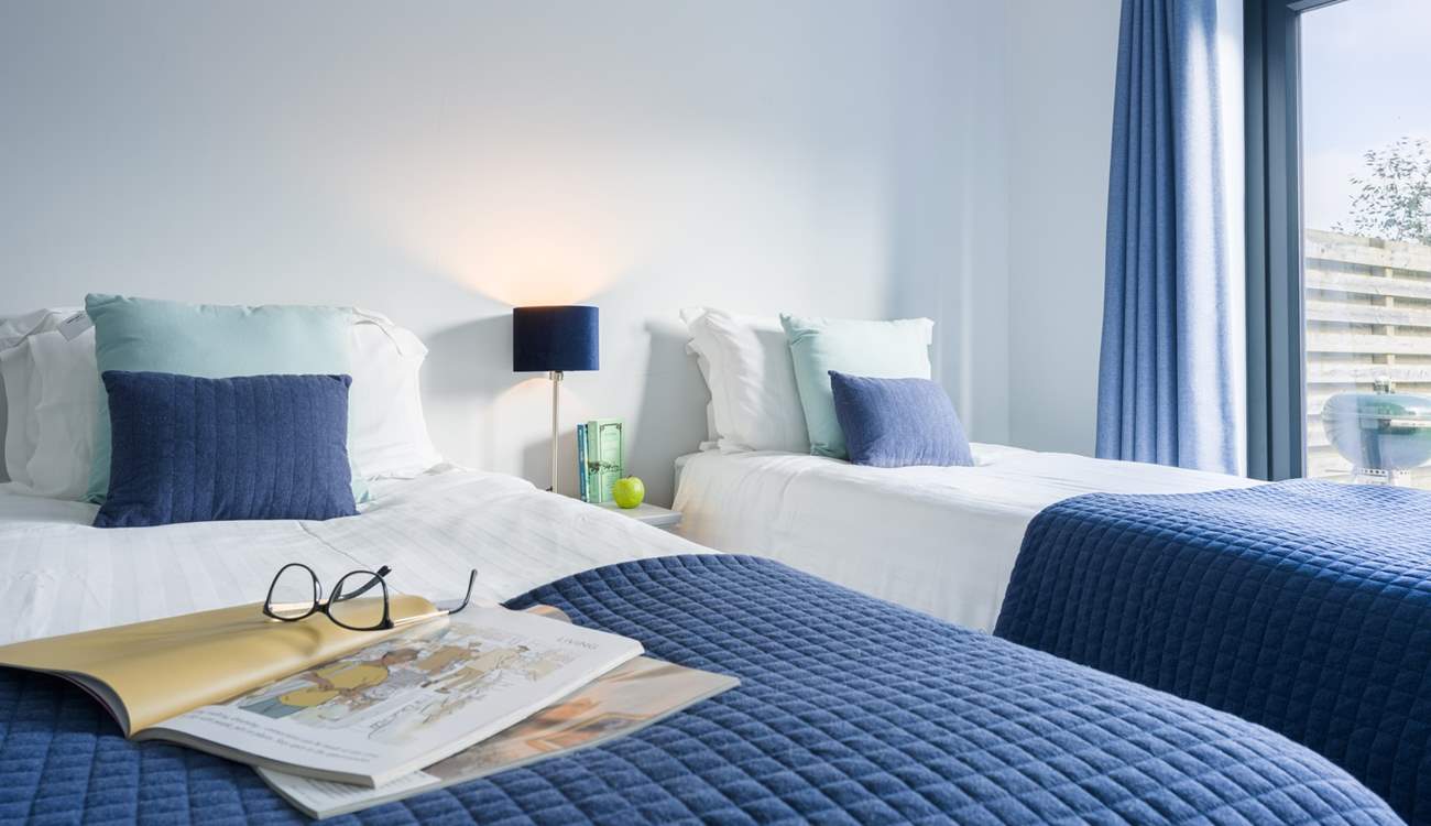 Decorated in coastal tones, the twin room will work for adults or children. There's also French doors out to the garden.