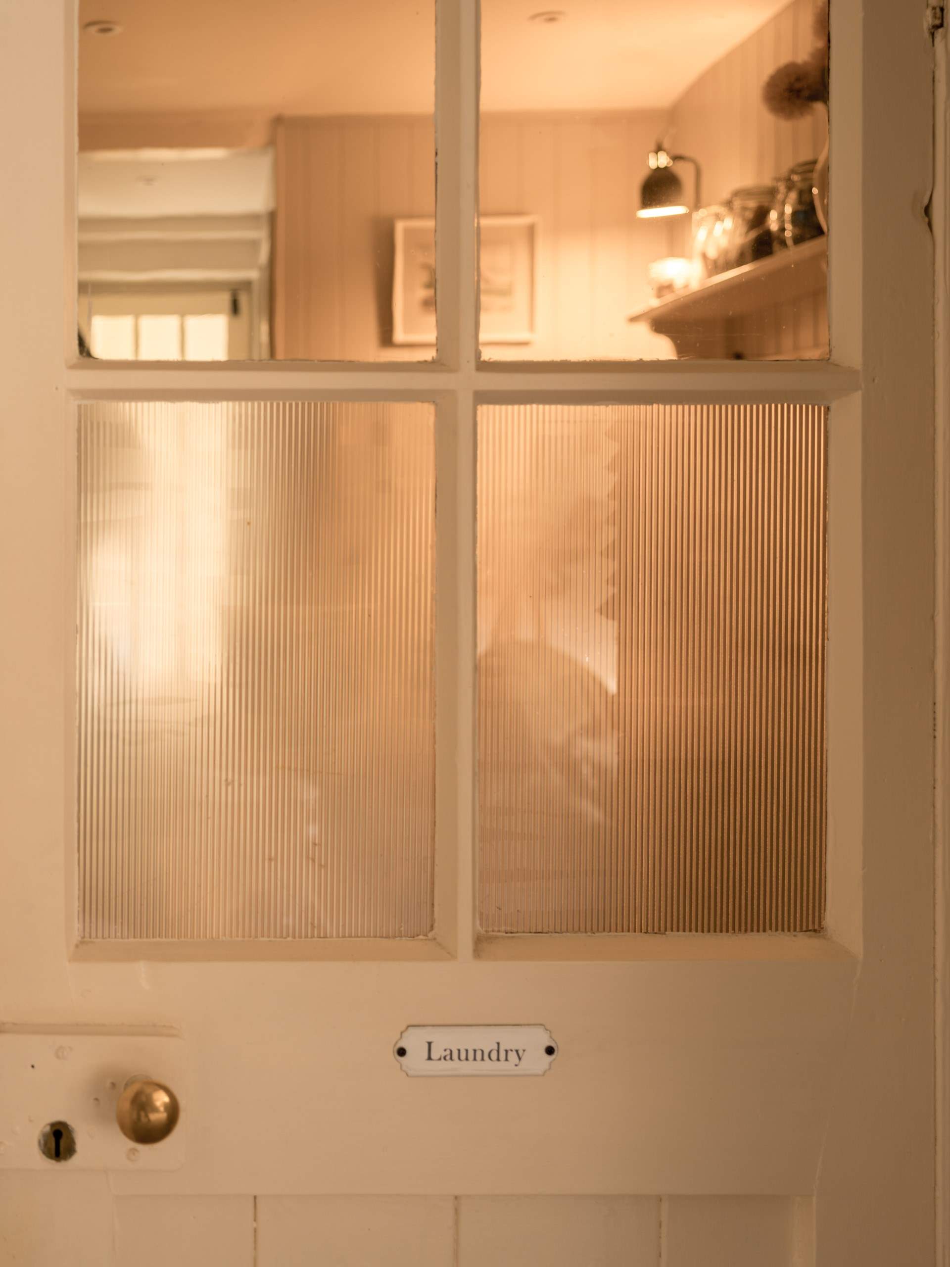 The utility-room is neatly closed off from the living spaces.