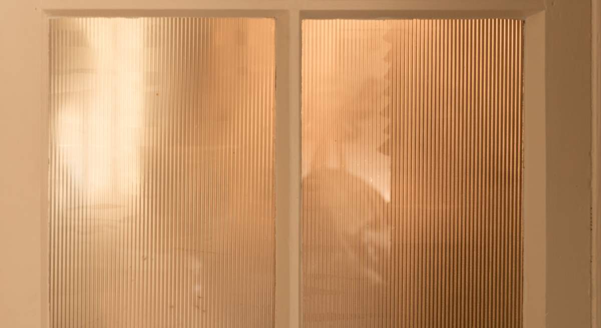 The utility-room is neatly closed off from the living spaces.