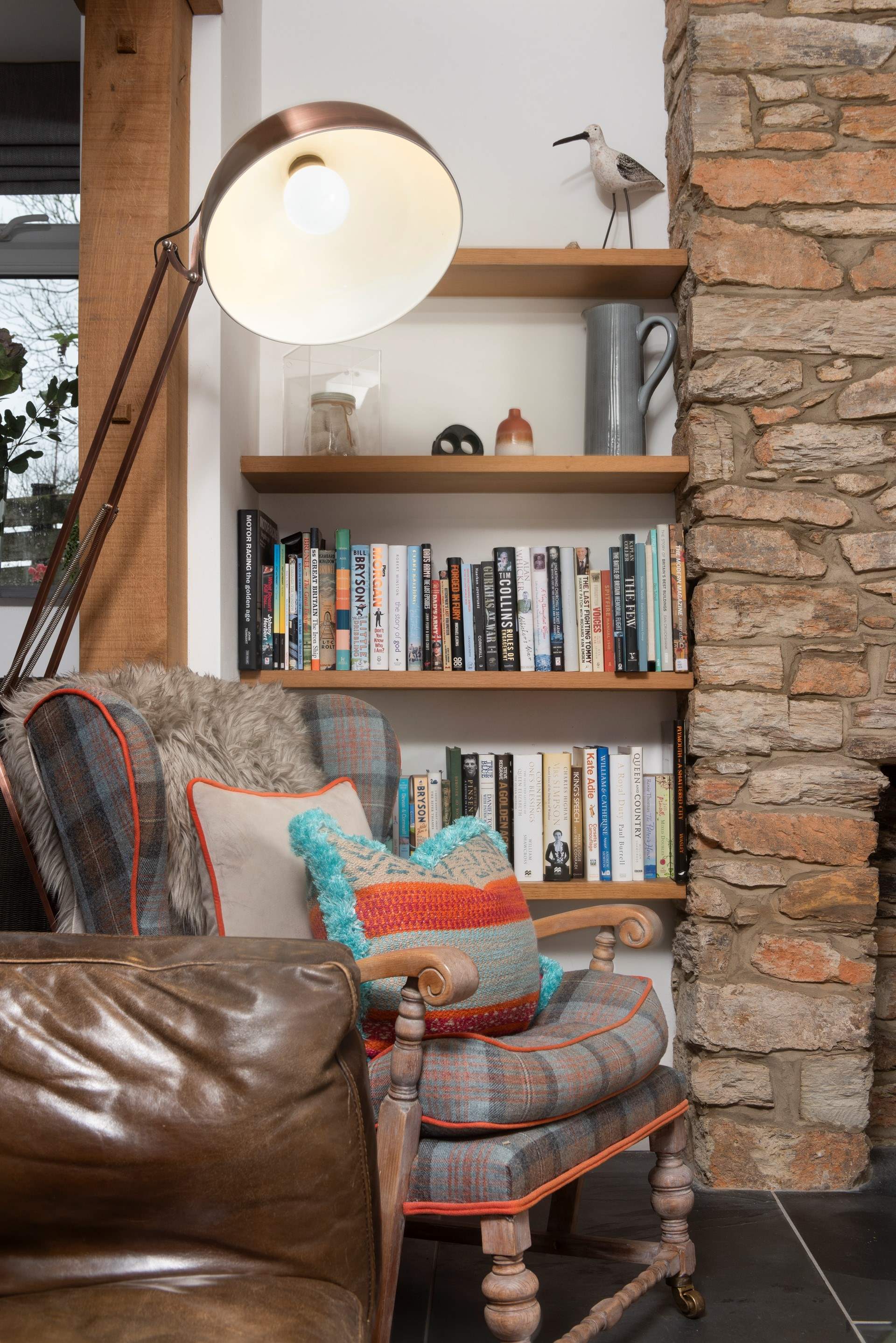 The shelves are stacked with a good selection of books .